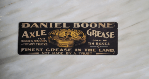 Front View of Daniel Boone Axle Grease Metal Sign